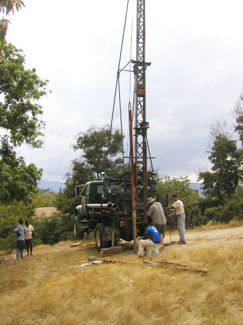 Glenn, Doug, and Michelin set up to begin drilling a well
